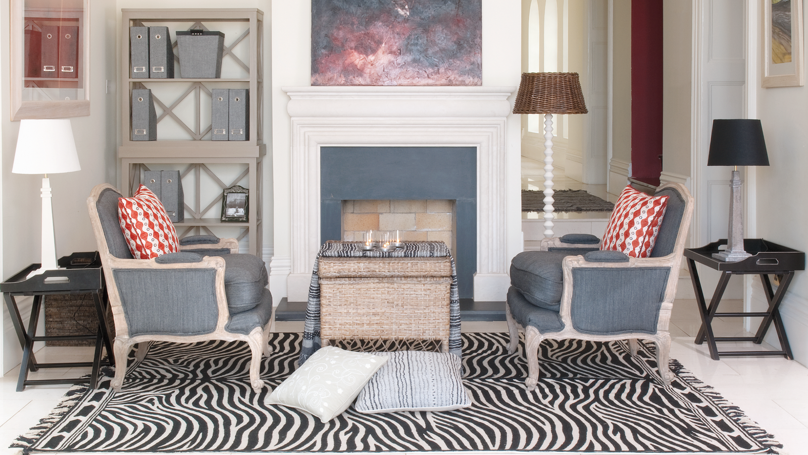 A Hedgeroe sitting room with a fireplace, patterned armchairs and a zebra-print rug — the opening frame of the Hedgeroe film